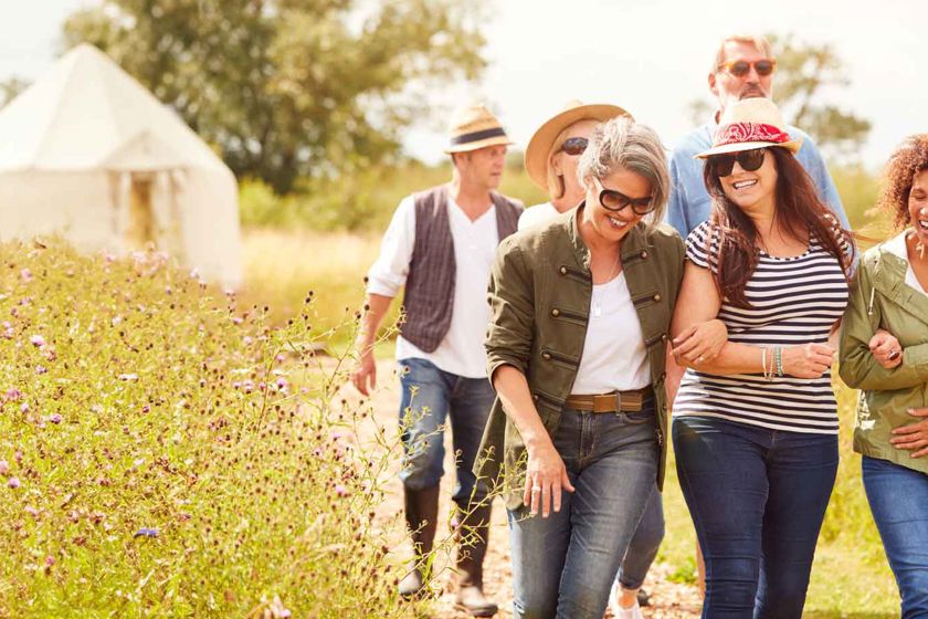 Group Of Friends Walking Through Field2 1 