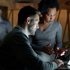 Coworkers Viewing Laptop Screen 