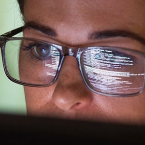 Woman Vieing Code On Computer Screen 