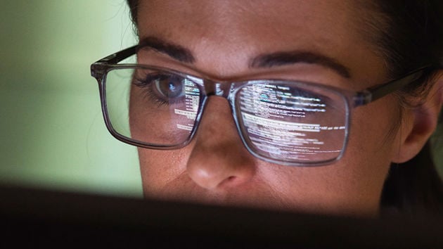 Woman Vieing Code On Computer Screen 