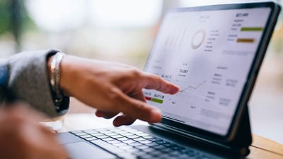 Close Up Of Finger Pointing To Pricing On Tablet 