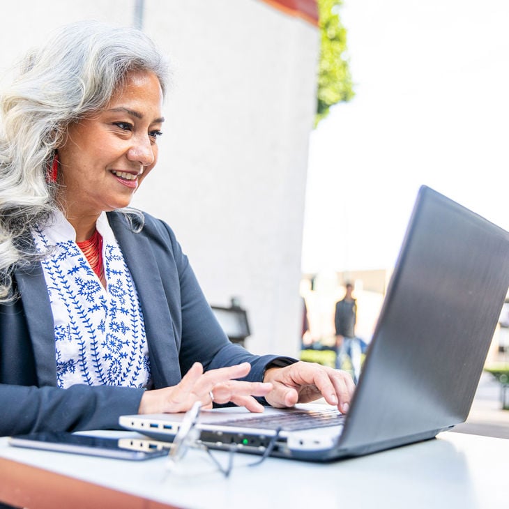 Person Happily Working On Laptop 
