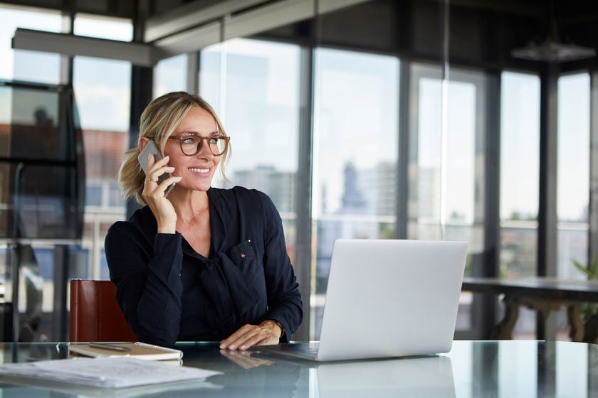 Office Worker Smiling While On The Phone 