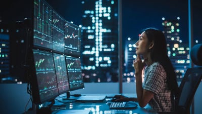 Office Worker Looking At Data In The Evening 