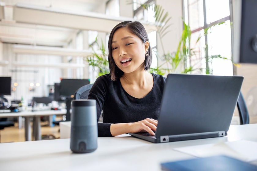 Worker Speaking To Virtual Assistant Technology