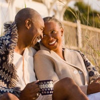 Happy Couple Sitting On Beach 