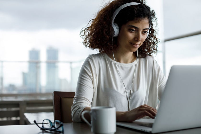 Person Wearing Headset At Laptop