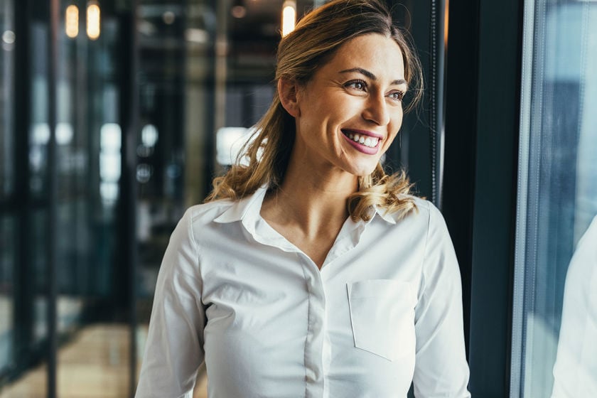 Happy Office Worker Looking Out Window 