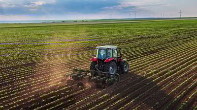 Farmland Horizon With Harvester 