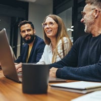 Colleagues Collaborating In Conference Room 