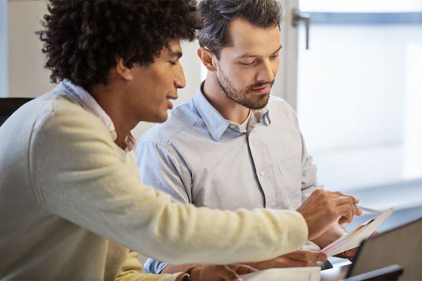 Two Coworkers Reviewing Files Teaser 