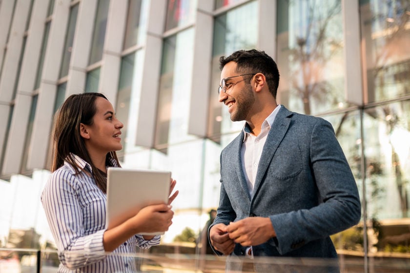 Two Colleagues Discussing Work Outside Of Building 