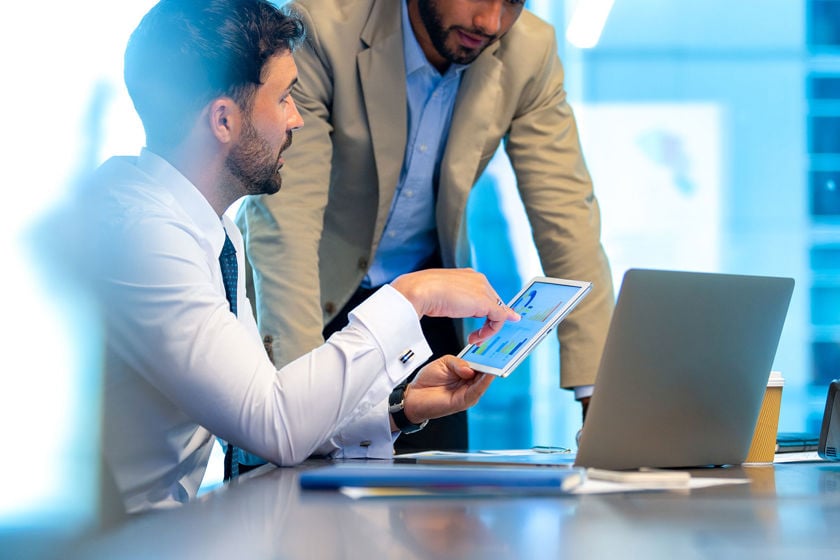 Two Colleagues Reviewing Data On A Tablet