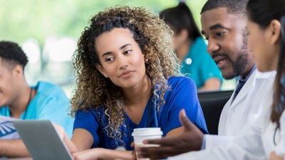 Colleagues Discussing Solution On Laptop 
