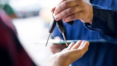 Man Handing Another Man Car Keys 