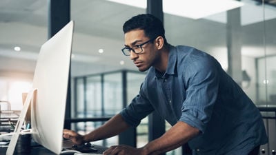 Person Leaning Over Desktop Screen 