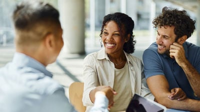 Happy People Shaking Hands At Table 