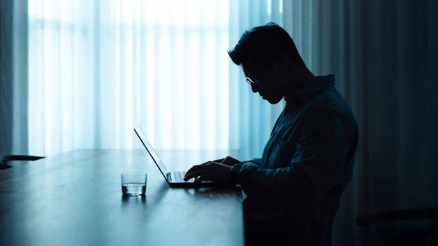 Man Working At Desk Dark 