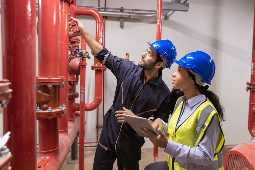 Technicians Inspecting Pipes 