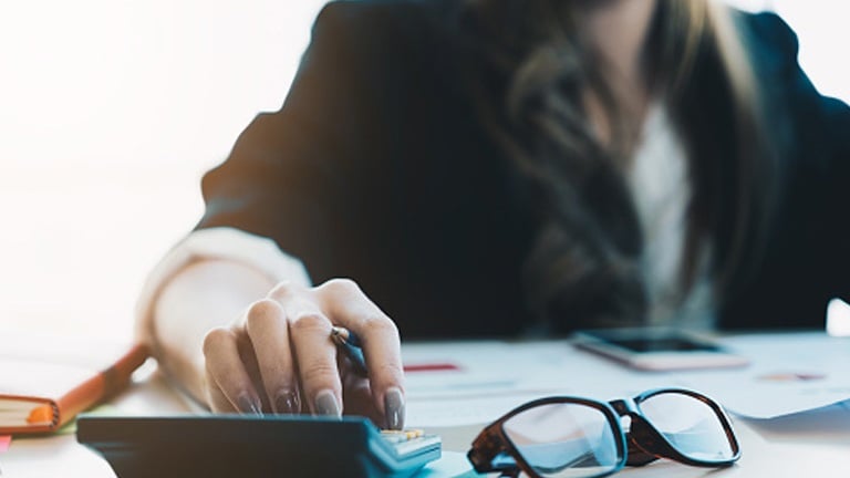 Woman with calculator Save