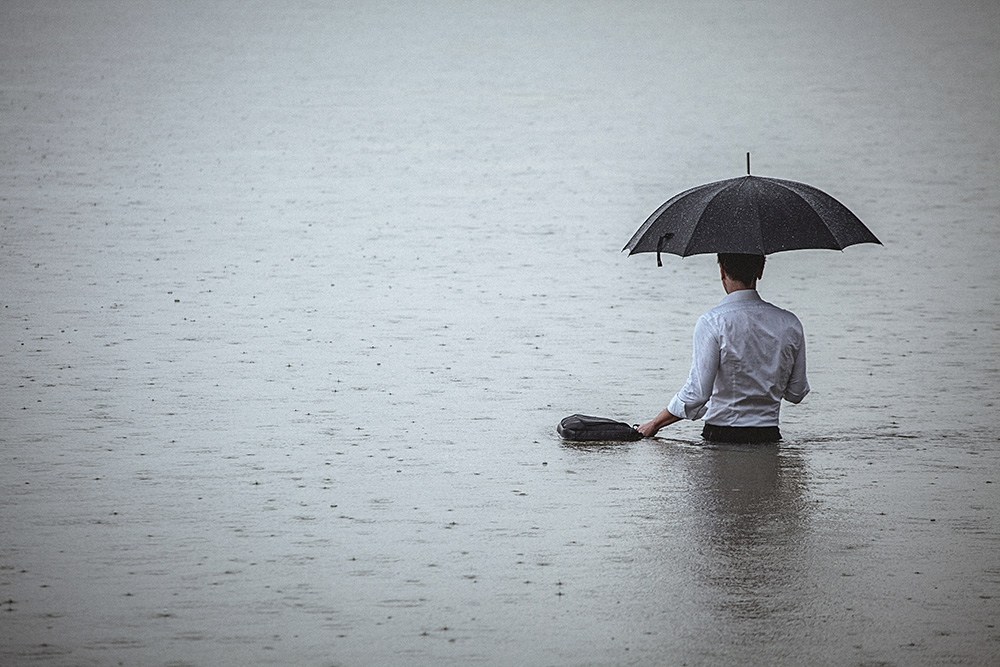man standing under umbrella