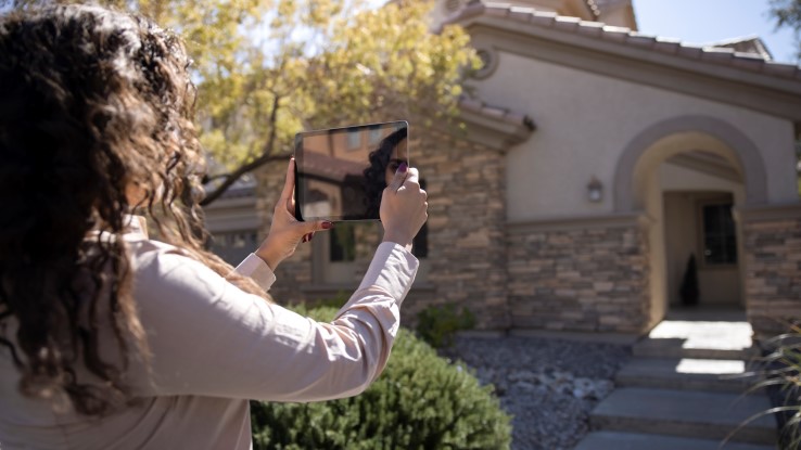 Women Taking Pictures Of Home With Ipad 