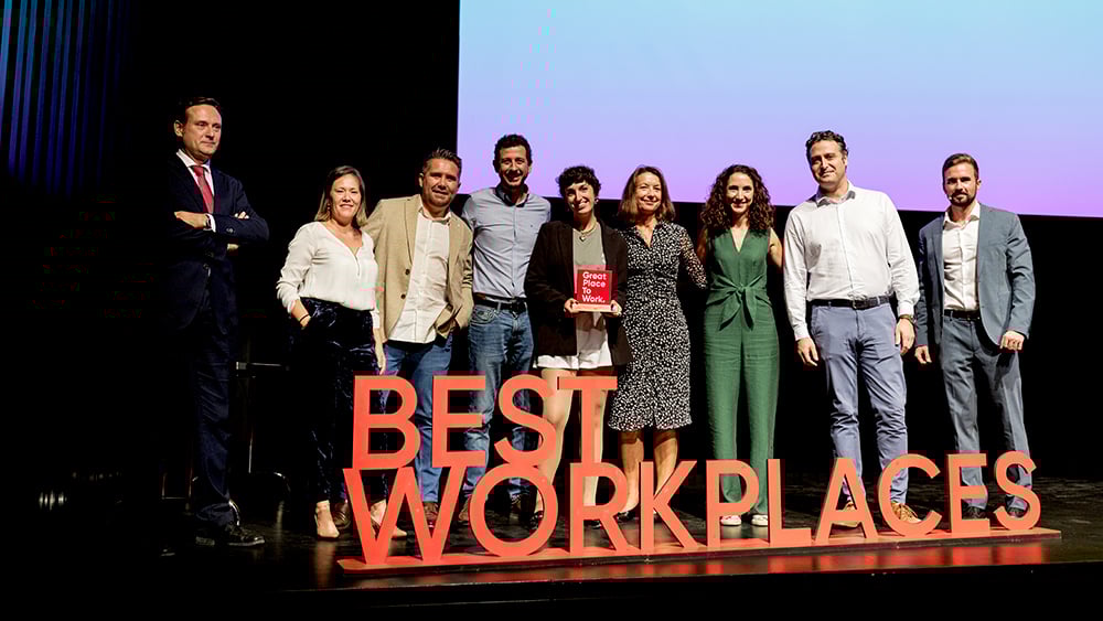 People on stage with Best Workplaces sign