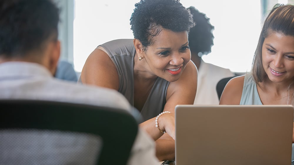 People looking at laptop