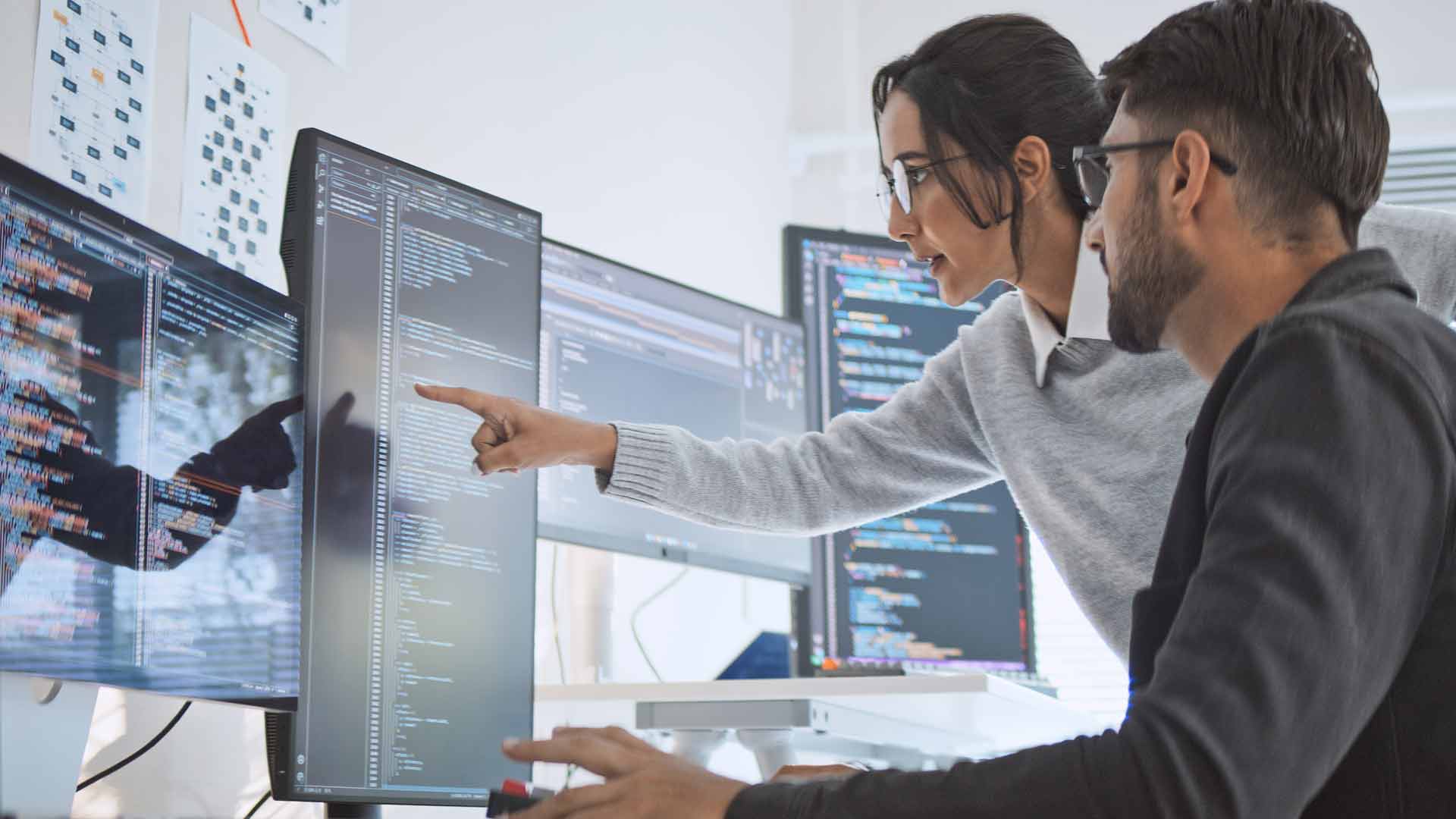 colleagues-reviewing-data-on-screen