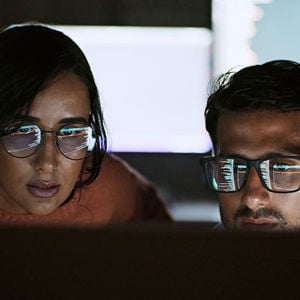 Two Coworkers Reviewing Ai Data 