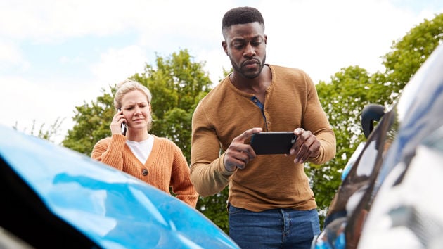 Man Taking Photo Of Car Accident 