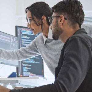 Colleagues Reviewing Data On Screen 