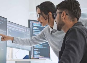 Colleagues Reviewing Data On Screen 