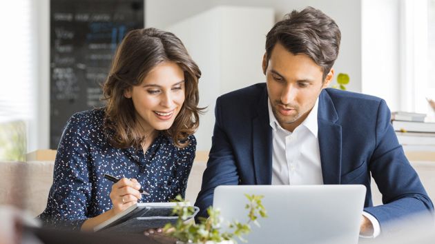 Reviewing Documents On A Laptop 
