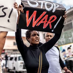 People Protesting Holding Signs War 