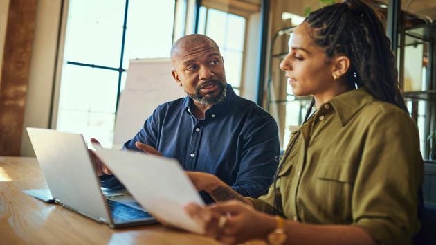 Man And Woman Reviewing Work 