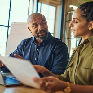 Man And Woman Reviewing Work 