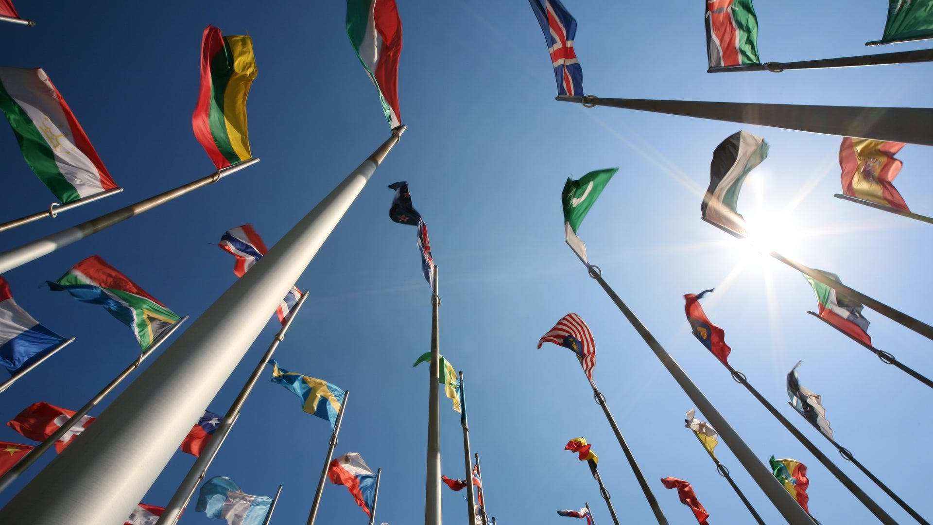 Country Flags Against A Sunny Blue Sky 