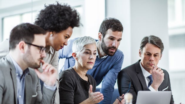 Colleagues looking at a laptop