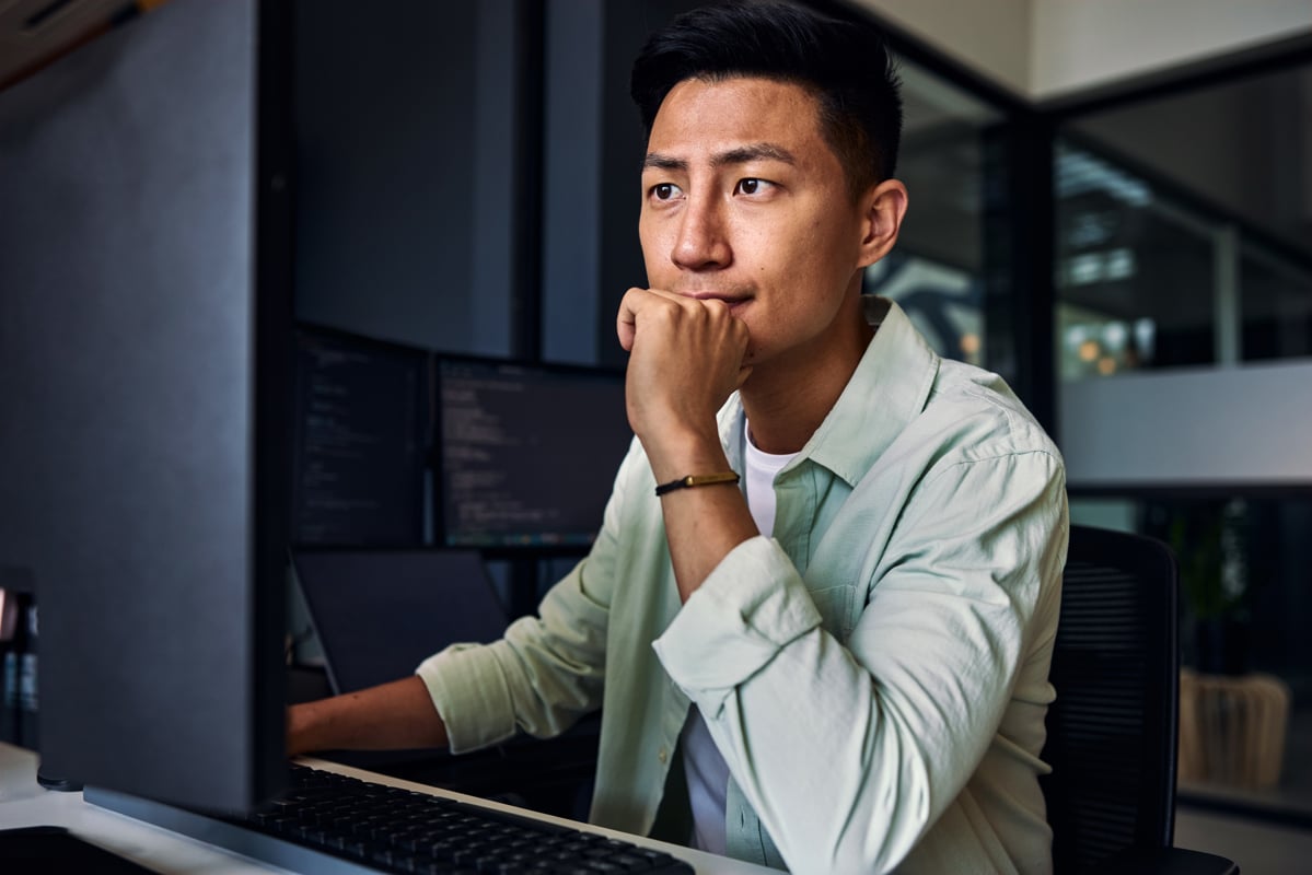 man looking at laptop at work