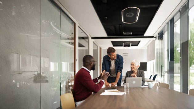 Coworkers Talking Sitting At Table 