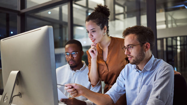 Coworkers At A Desktop 