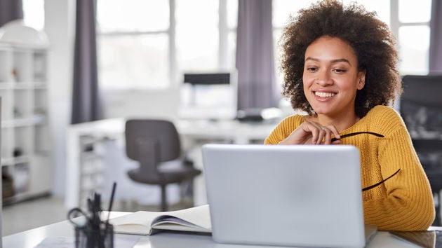 Woman In Yellow Sweater In Office 