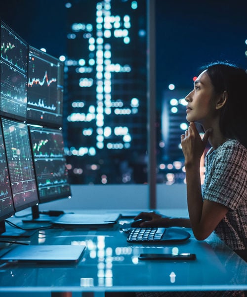 Office Worker Looking At Data In The Evening 