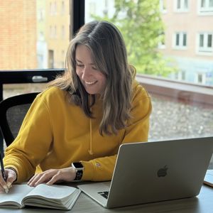 Woman Wearing Yellow Writing In Notebook Laptop 
