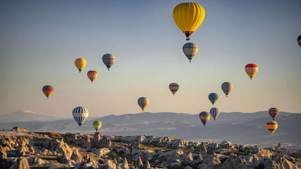 Hot Air Ballons Over Mountain Range 