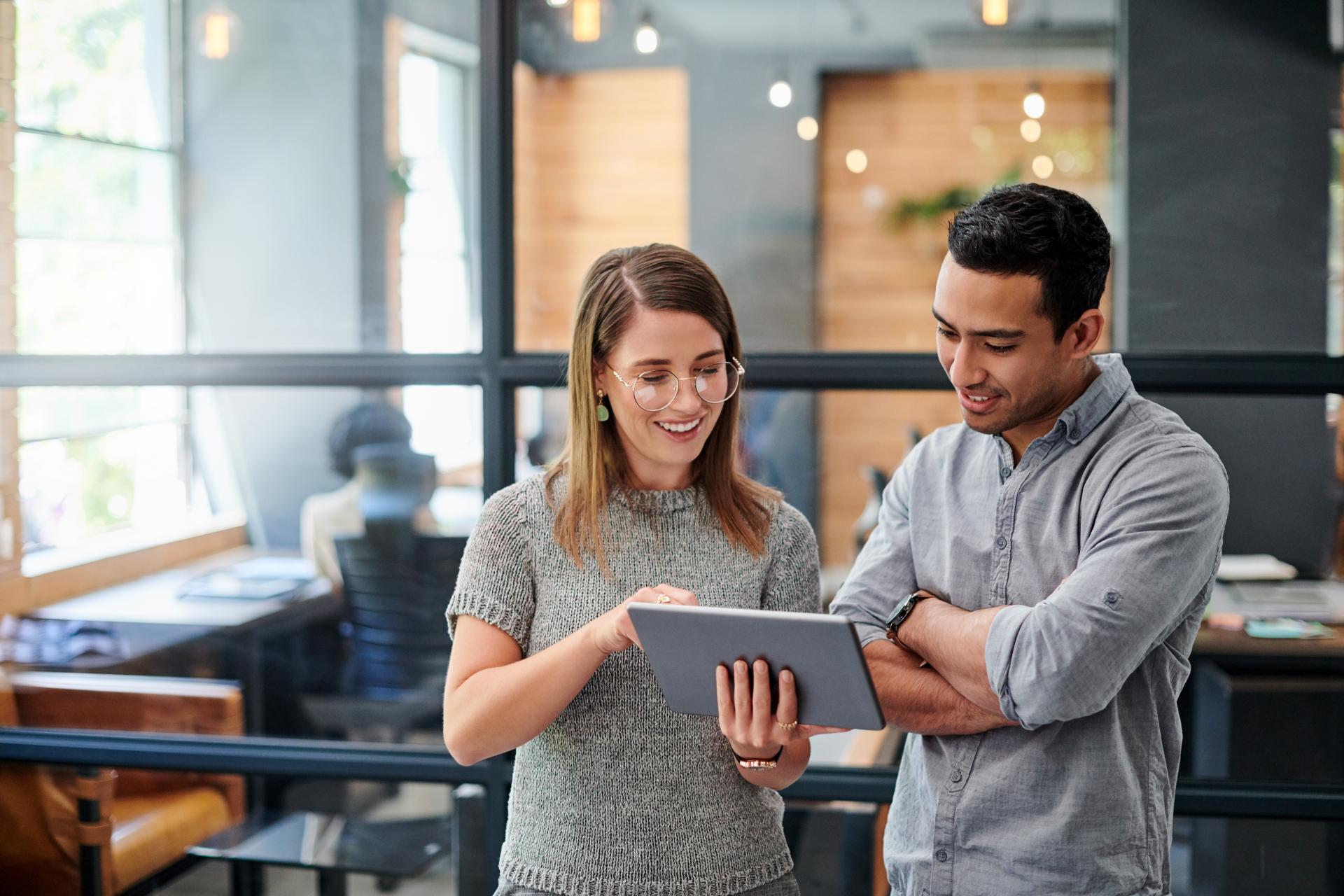 Two Coworkers Reviewing Tablet 