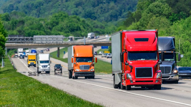 Many Semi Trucks Traveling Down Highway 