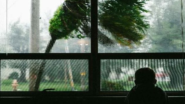 South Korea Typhoon Child Looking Out Window 