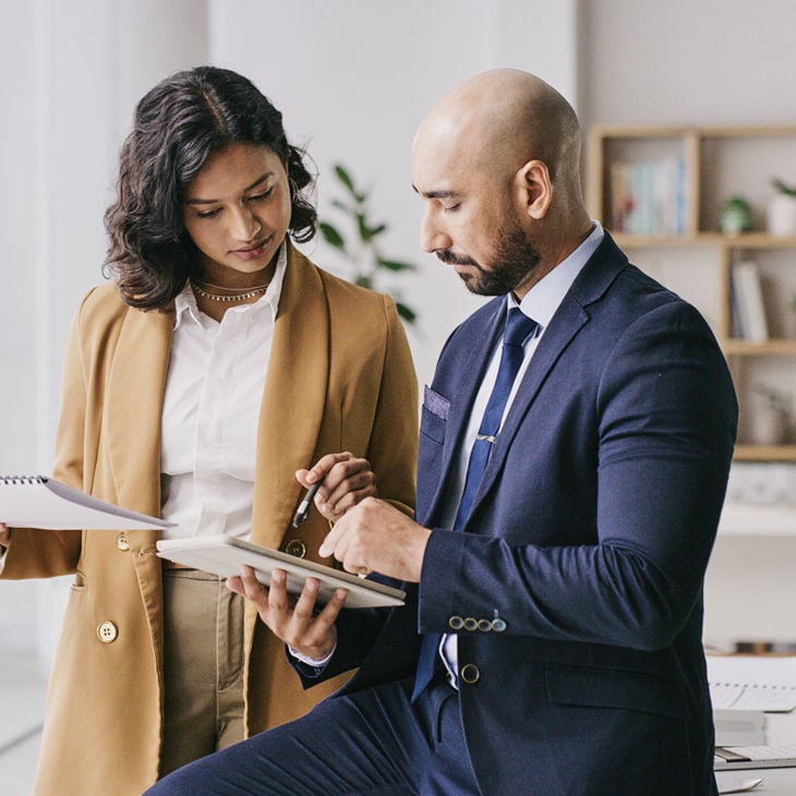 Coworkers Reviewing Data On Tablet Computer 